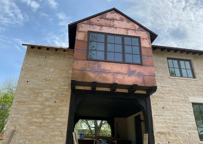 Copper metal panel facade on a stone building for Metal Roof Coating in Ambridge
